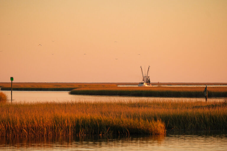 View of shrimp boat on the waterway at sunset